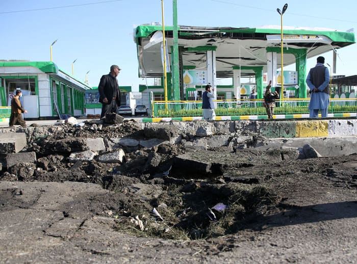 Afghan men walk past from the site of a suicide bomb attack in Kabul, Afghanistan, April 21, 2021. (CNS photo/Omar Sobhani, Reuters)