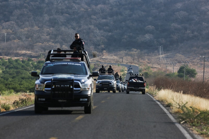 A state police convoy patrols a road near Aguililla, Mexico, April 23, 2021, after a visit from Archbishop Franco Coppola, the apostolic nuncio to Mexico. Drug cartels have battled each other and blocked highways in the town, leaving residents unable to travel freely and causing shortages of everything from food to fuel. (CNS photo/Alan Ortega, Reuters)