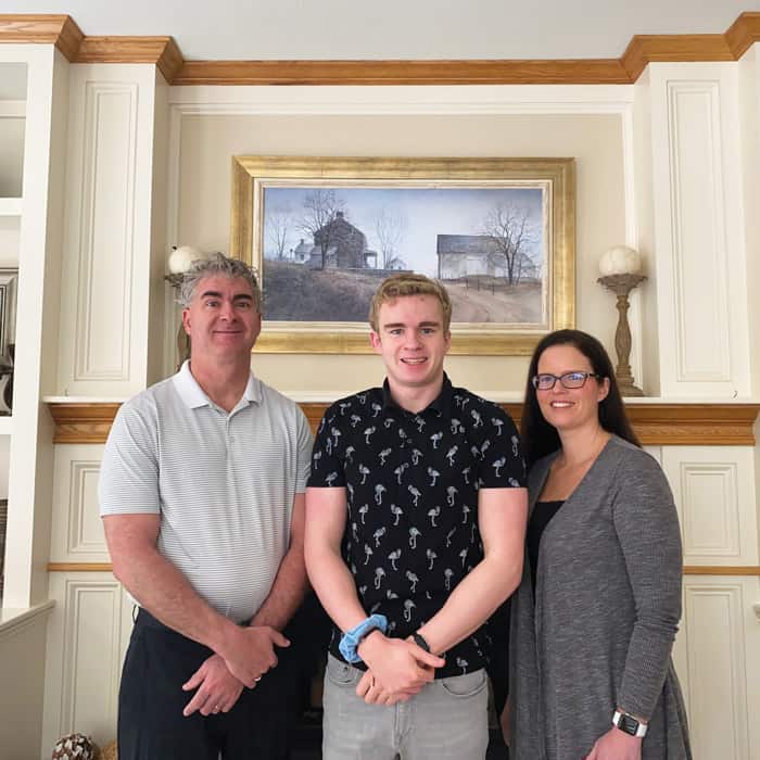 Flanked by his parents, Chris and Kimberly, Conner Cruise, a 12th-grader at Cedar Rapids Washington High School in Cedar Rapids, Iowa, wins the first-place Bishop Patrick J. Byrne Award for Division II of the Maryknoll Student Essay Contest.