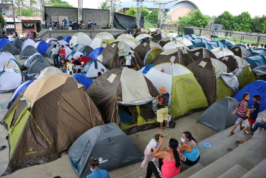 Venezuelan refugees are seen inside a coliseum in Arauquita, Colombia, April 5, 2021. A temporary camp was set up after the Venezuelans fled their country due to a military offensive. (CNS photo/Reuters)