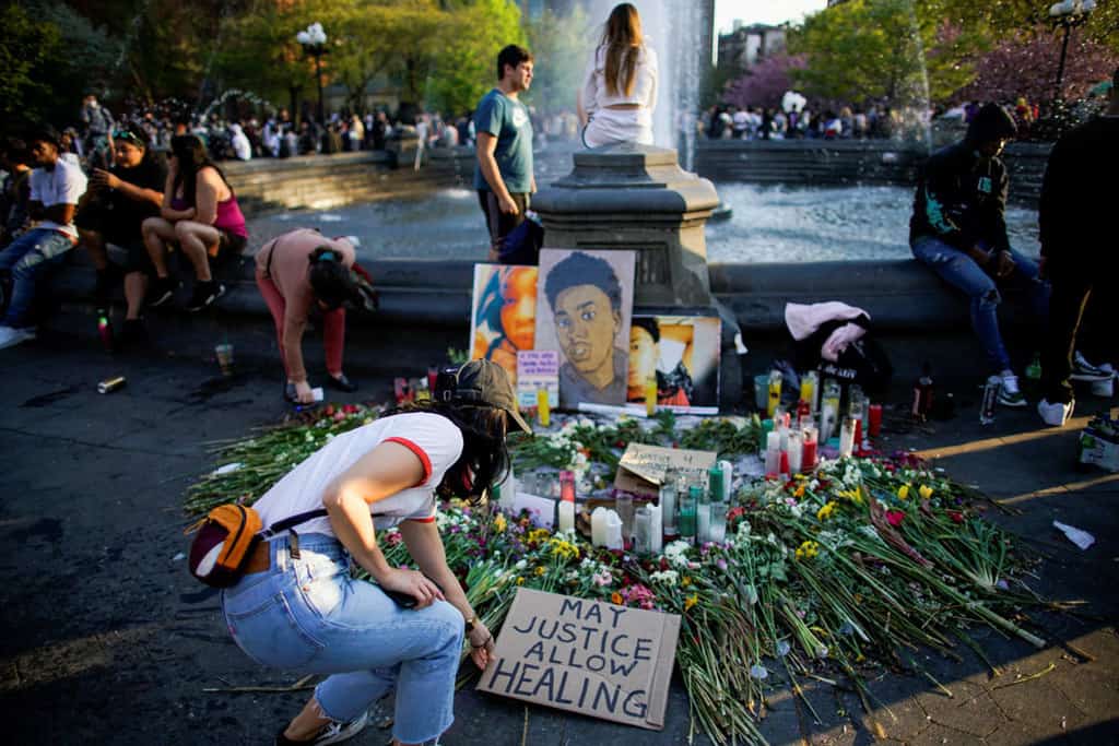 People in New York City are seen near a makeshift memorial April 20, 2021, after jurors issued their verdict convicting former Minneapolis police officer Derek Chauvin of second-degree unintentional murder, third-degree murder and second-degree manslaughter in the death of George Floyd. (CNS photo/Eduardo Munoz, Reuters)