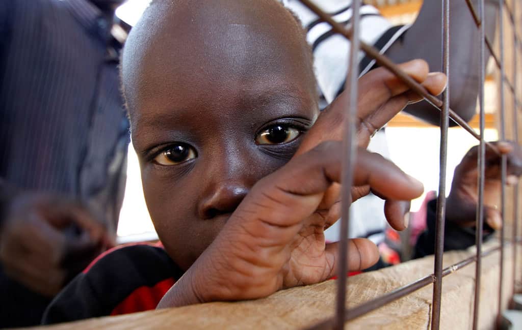 A child from South Sudan is pictured in a 2012 photo at a registration center in the Kakuma refugee camp in northern Kenya. Catholic bishops in Kenya are urging the government to shelve plans to close Dadaab and Kakuma refugee camps that host refugees who fled civil war and famine in Somalia and South Sudan. (CNS photo/Thomas Mukoya, Reuters)