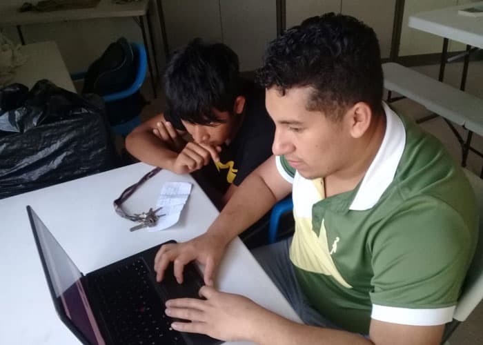 Luis Miguel helping Jefferson with homework (Courtesy of MKLM/El Salvador)