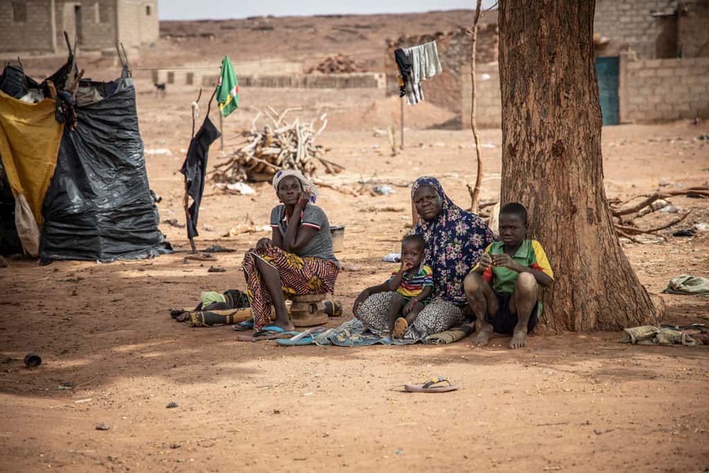 Displaced women and children rest in the shade in Kaya, Burkina Faso, June 4, 2020. Catholic and Muslim leaders are working jointly to deter youth from terrorist violence in Africa's Sahel region. (CNS photo/Olympia de Maismont for Catholic Relief Services)