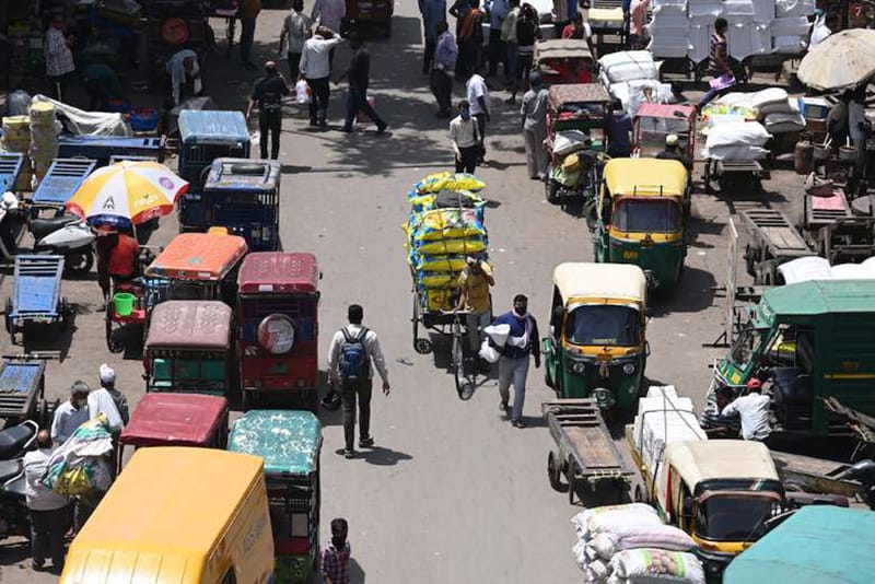 People make their way along a street in the old quarters of New Delhi on April 19 as India's capital prepares to impose a week-long lockdown. (Photo: Sajjad Hussain/AFP)