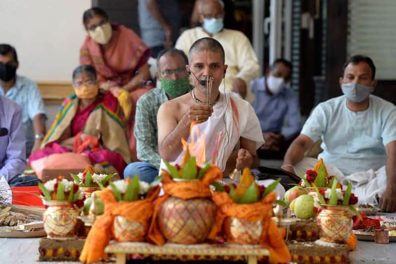 Hindu priests perform a ritual wishing to globally eradicate the coronavirus pandemic at a temple in Hyderabad, India, on April 13. A spike in cases forced a week-long lockdown in New Delhi on April 19. (Photo: Noah Seelam/AFP)