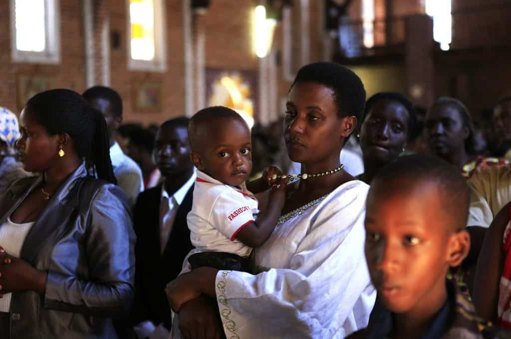 RWANDA FAMILY CHURCH A family attends Mass in 2014 at a Catholic church in Kigali, Rwanda, where Christianity is growing.. The Rwandan bishops' conference urged steps be taken to ensure religious freedom after the government closed thousands of churches.(CNS photo/Noor Khamis, Reuters) See RWANDA-CHURCHES-RELIGIOUS-FREEDOM Aug. 14, 2018.