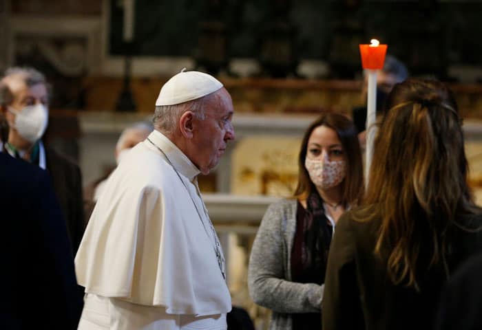 Young people carry candles in procession as Pope Francis arrives to pray the rosary with a small number of the faithful in St. Peter's Basilica at the Vatican May 1, 2021. The pope began a monthlong rosary marathon praying for an end to the COVID-19 pandemic. (CNS photo/Paul Haring)