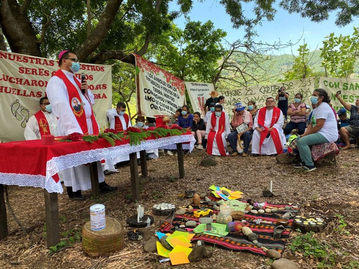 Sumpul river massacre: Bishop Oswaldo Estéfano Escobar Aguilar of the Diocese of Chalatenango, El Salvador, celebrates Mass on the banks of the Sumpul River in northern El Salvador May 14, 2021, during the commemoration of the 41st anniversary of the massacre of 600 people. In 1980 U.S.-trained members of the Salvadoran military killed more than 600 unarmed civilians along the riverbed. Survivors and family of those killed asked for justice as they marked the anniversary. (CNS photo/Rhina Guidos)