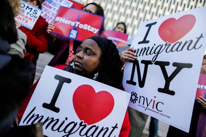 reprieve for Haitians: Haitian immigrants and supporters in New York City hold placards in support of Temporary Protected Status in this 2017 file photo. On May 22, 2021, the Biden administration granted eligible Haitian nationals living in the United States the chance to apply for a new 18-month TPS designation. (CNS photo/Eduardo Munoz, Reuters)