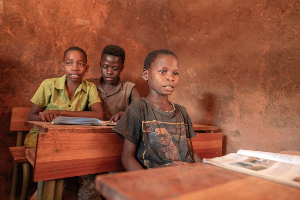 Displaced boys participate in school work in a camp in Mozambique's Cabo Delgado province in this 2019 photo. Residents in northern Mozambique, a region rich in natural gas deposits, have been grappling with an Islamist insurgency since 2017. (CNS photo/Alessandro Grassani, courtesy AVSI)