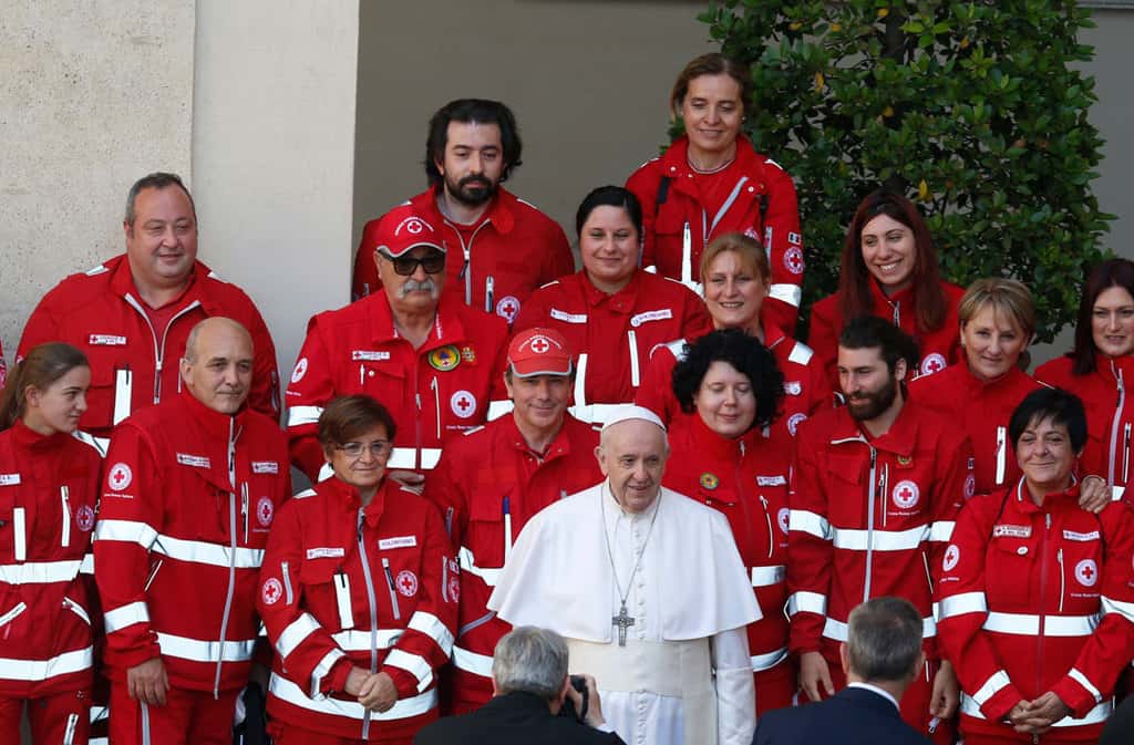Pope Francis poses for a photo with members of the Italian Red Cross during his general audience in the San Damaso Courtyard of the Apostolic Palace at the Vatican May 26, 2021. (CNS photo/Paul Haring)