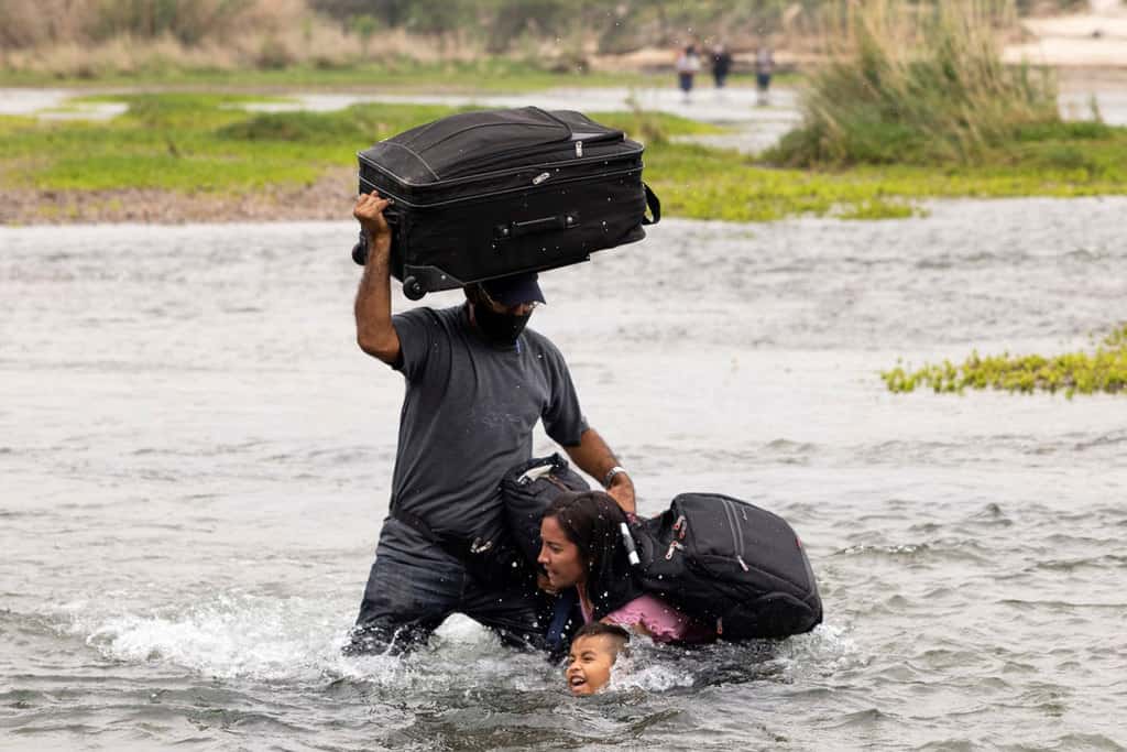 Migrants from Venezuela seeking asylum in the U.S. cross the Rio Grande into Del Rio, Texas, May 10, 2021. (CNS photo/James Breeden, Reuters)