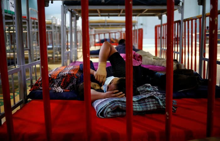 A migrant from Central America who was airlifted from Brownsville, Texas, to El Paso, Texas, and then deported with her son are seen at a temporary temporary shelter in Ciudad Juarez, Mexico, April 5, 2021. (CNS photo/Jose Luis Gonzalez, Reuters)