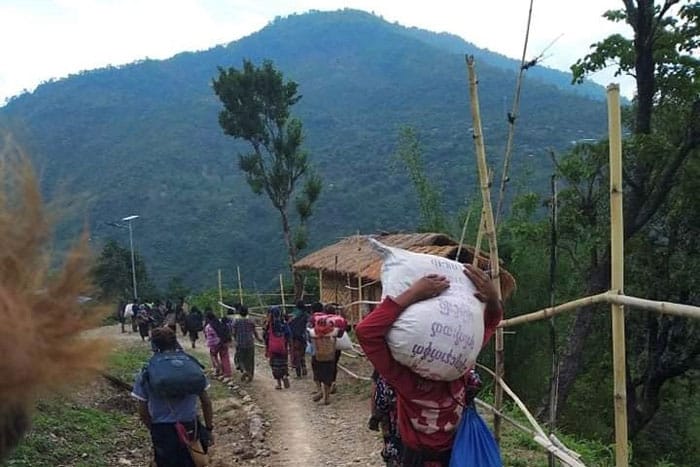 20210607T1015-MYANMAR-CHURCHES-MILITARY-STRIKES-1249758-(1) People in northwestern Myanmar displaced by fighting between junta forces and anti-junta fighters walk in Chin state May 31, 2021. A third church in Kayah state, a Catholic stronghold in eastern Myanmar, was damaged by indiscriminate shelling by the military June 6. (CNS photo/Reuters)