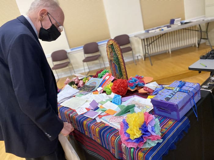 Bishop Guido Charbonneau of Honduras looks at notes written by children in detention camps during a break June 1, 2021, at Mundelein Seminary outside of Chicago. Along with other bishops from Central America and Mexico, he was participating in an emergency meeting June 1, 2 at the urging of U.S. bishops to address immigration. (CNS photo/Rhina Guidos)