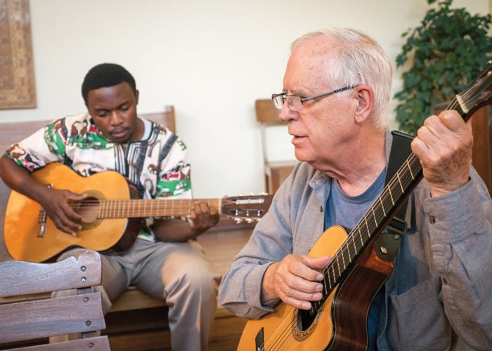 Seminarian Joshua Mutende and Maryknoll Father Paul Masson, spiritual guide for Maryknoll candidates in Bolivia, play guitar during Mass at Maryknoll chapel in Cochabamba. (Nile Sprague/Bolivia)