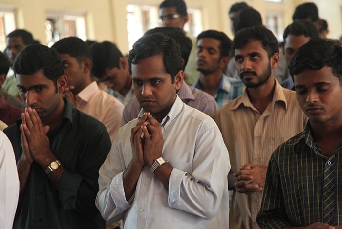 PRAY SEMINARY INDIA After World Mission Sunday Mass at St. Ferdinand Church, pastor Father Jason Torba and Cardinal Blase Cupich greet the congregation, including all those who do mission in Chicago. (Julie Jaidinger, Chicago Catholic/U.S.)