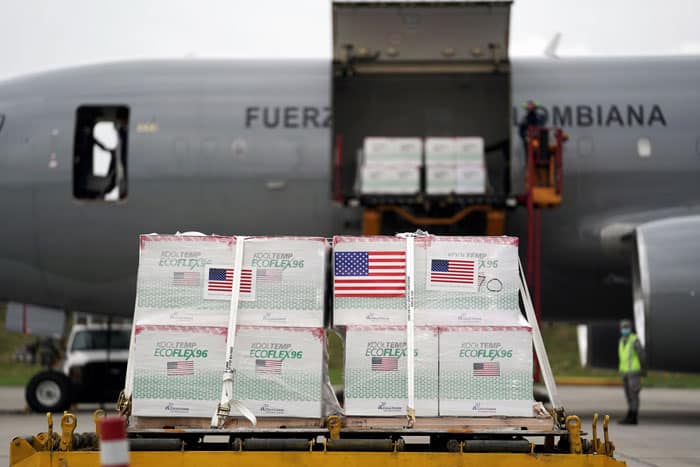 20210702T0830-VACCINES-VATICAN-MEDICAL-ASSOCIATIONS-1251284 U.S. flags are taped on a shipment of Johnson & Johnson COVID-19 vaccines in Bogota, Colombia, July 1, 2021. (CNS photo/Nathalia Angarita, Reuters)