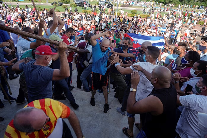 CUBA PROTEST After World Mission Sunday Mass at St. Ferdinand Church, pastor Father Jason Torba and Cardinal Blase Cupich greet the congregation, including all those who do mission in Chicago. (Julie Jaidinger, Chicago Catholic/U.S.)