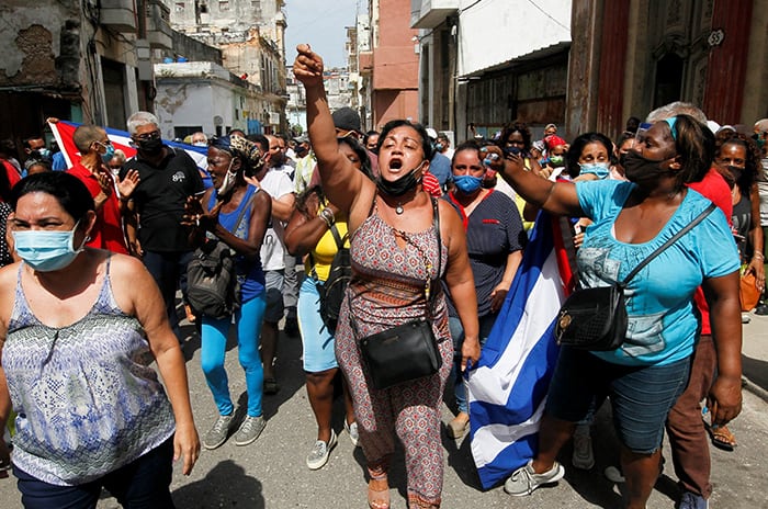 CUBA PROTEST After World Mission Sunday Mass at St. Ferdinand Church, pastor Father Jason Torba and Cardinal Blase Cupich greet the congregation, including all those who do mission in Chicago. (Julie Jaidinger, Chicago Catholic/U.S.)