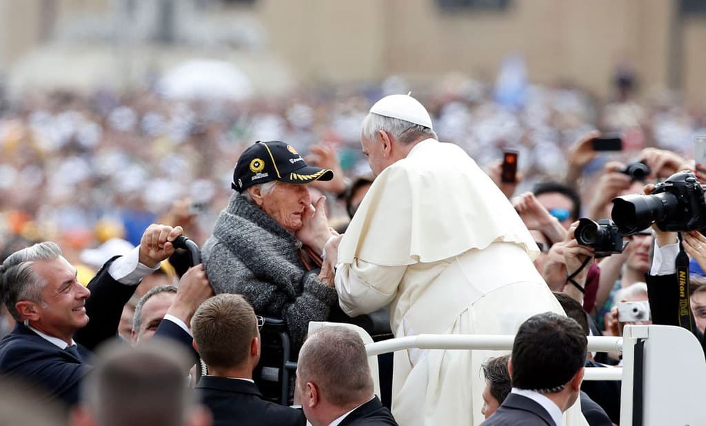 An elderly woman becomes emotional as Pope Francis greets her as he arrives for a May 2014 weekly audience in St. Peter's Square at the Vatican. Pope Francis wanted the first World Day for Grandparents and the Elderly on July 25 to be inaugurated as the world seeks to recover from a deadly pandemic, calling for the faithful to be "angels," who care, console and caress. (CNS photo/Tony Gentile, Reuters)