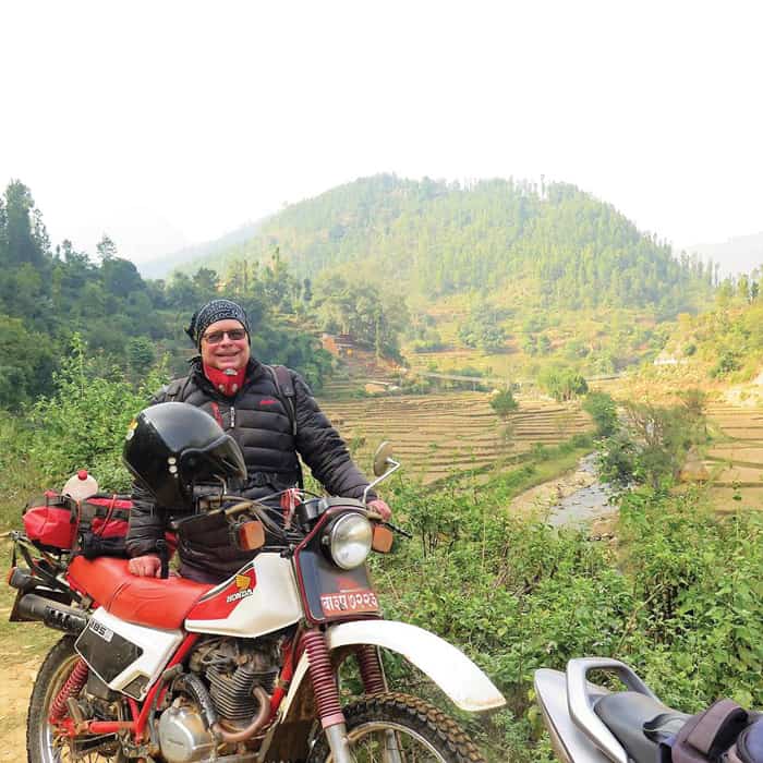 24-29-Thaler01 Maryknoll Father Joseph Thaler has logged thousands of miles over rough terrain on his 30-year-old Honda XL 185 motorcycle to visit the Nepalese. (Courtesy of Joseph Thaler/Nepal)