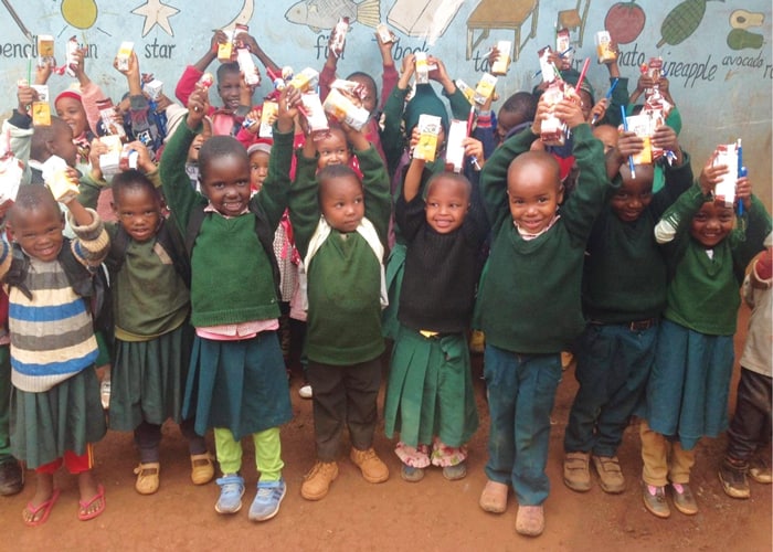 Students at St. Paul Academy who could not afford uniforms and backpacks received them along with snacks for all from Hope on Hooves. (Courtesy of Samson Gladstone/Tanzania)