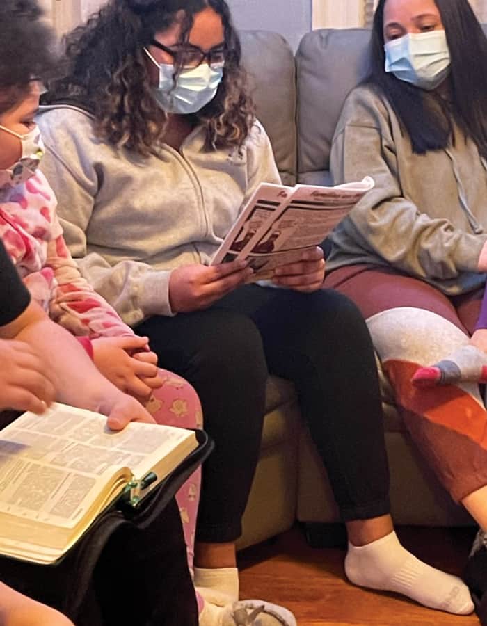 At a weekly prayer encounter during Lent of 2021, Kayla Lopez reads the Maryknoll study guide as other participants listen and reflect. (Courtesy of Alejandro Lopez-Cardinale/U.S.)