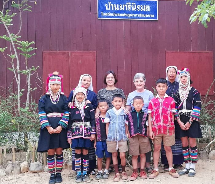 Along with a fellow Maryknoll volunteer (third from right), Doctor Anna Morris (back row, second from left) accompanies members of a local congregation, the Missionary Sisters of the Immaculate Conception, in their ministry to villagers of the Akha and Karen hill tribes in northern Thailand. (Courtesy of Anna Morris/Thailand)