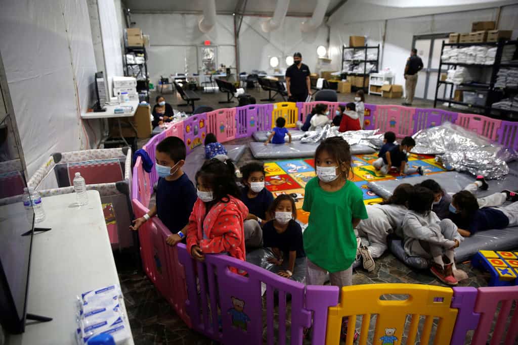 web-CHILDREN-MIGRANT-FACILITY-1505107 Young unaccompanied migrants, ages 3 to 9, watch television inside a playpen March 30, 2021, at the holding facility in Donna, Texas, set up in February by U.S. Customs and Border Protection, an agency within the Department of Homeland Security. (CNS photo/Dario Lopez-Mills, Pool via Reuters)