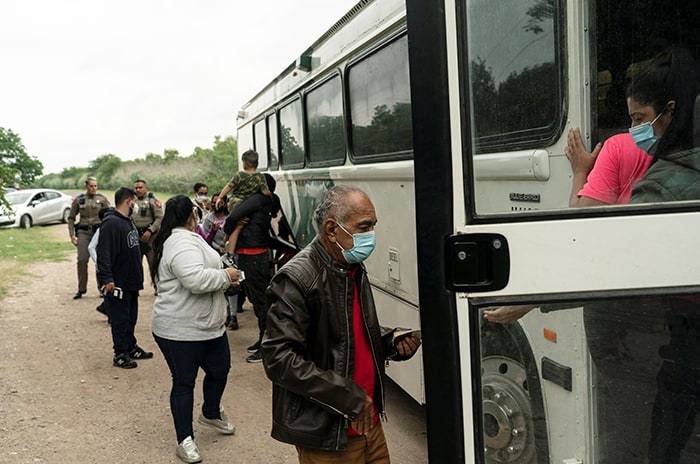 MIGRANTS TEXAS After World Mission Sunday Mass at St. Ferdinand Church, pastor Father Jason Torba and Cardinal Blase Cupich greet the congregation, including all those who do mission in Chicago. (Julie Jaidinger, Chicago Catholic/U.S.)