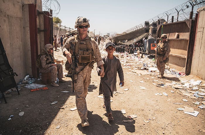 Father Scalese and others flee Kabul - A U.S. Marine escorts a child to his family during an evacuation at Hamid Karzai International Airport in Kabul, Afghanistan, Aug. 24, 2021. (CNS photo/Sgt. Samuel Ruiz/U.S. Marine Corps/handout via Reuters)