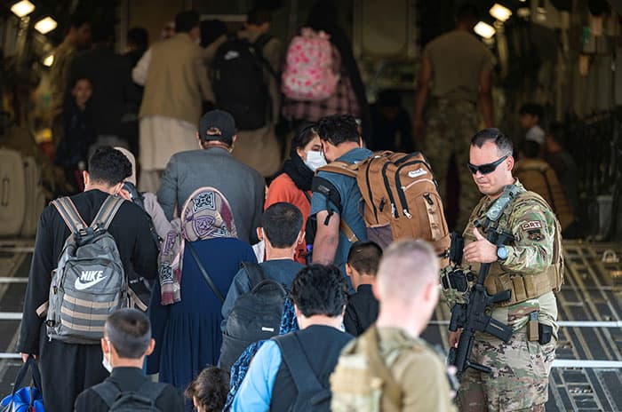 Father Scalese and others flee Afghanistan: U.S. Air Force members guide qualified evacuees aboard a C-17 Globemaster III at Hamid Karzai International Airport in Kabul, Afghanistan, Aug. 24, 2021. (CNS photo/U.S. Air Force/Senior Airman Taylor Crul/handout via Reuters)