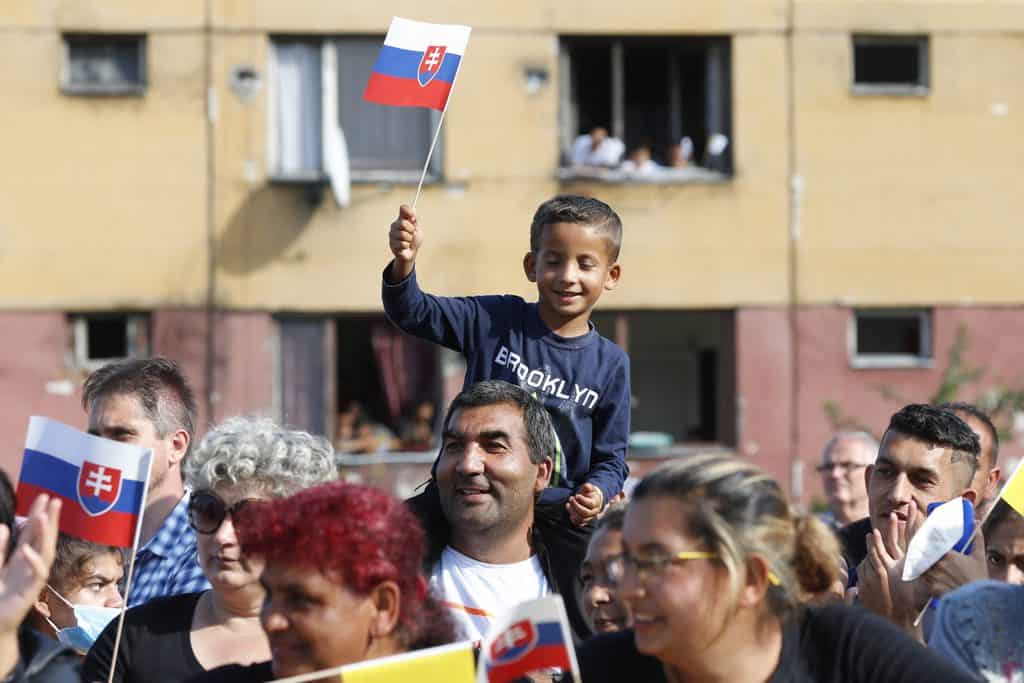 PAPAL TRIP HUNGARY SLOVAKIA People wait for Pope Francis' arrival for a meeting with the Roma community in the Luník IX neighborhood in Koice, Slovakia, Sept. 14, 2021. After the visit to Hungary and Slovakia the pope spoke about communion on the papal plane. (CNS photo/Paul Haring)