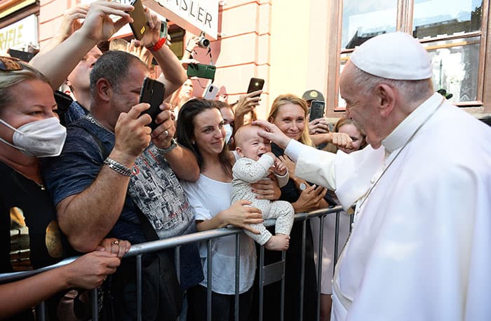 PAPAL TRIP HUNGARY SLOVAKIA After World Mission Sunday Mass at St. Ferdinand Church, pastor Father Jason Torba and Cardinal Blase Cupich greet the congregation, including all those who do mission in Chicago. (Julie Jaidinger, Chicago Catholic/U.S.)