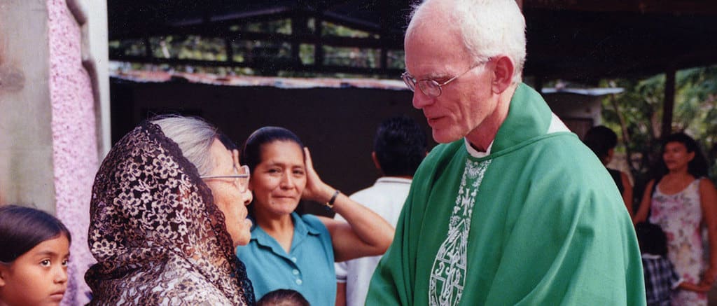 As a Maryknoll priest in El Salvador in 2004, Father James Lynch greeted his parishioners after Sunday Mass. (Bernice Kita/El Salvador)