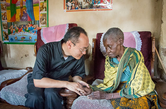 Father Lam Hua (center) talking to Victoria Maltini (right), Mabatini, Mwanza, Tanzania. Photo © Nile Sprague