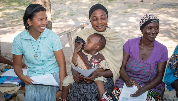 Maryknoll Sister Genie Natividad (left), with Farida Joseph Msipi holding son Houseni and Maryciana Paulo, ran an HIV/AIDS group in Mwanza. (Nile Sprague/Tanzania)