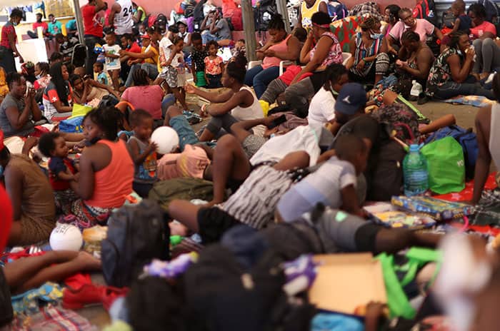 HAITIAN MIGRANTS MEXICO After World Mission Sunday Mass at St. Ferdinand Church, pastor Father Jason Torba and Cardinal Blase Cupich greet the congregation, including all those who do mission in Chicago. (Julie Jaidinger, Chicago Catholic/U.S.)