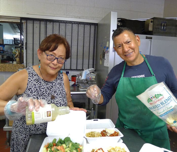 Lay Missioner Coralis Salvador and Chef James Martinez prepare meals for day laborers, homeless people and migrants at La Tilma, a program of Sacred Heart parish in El Paso.