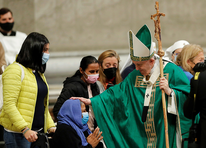 After World Mission Sunday Mass at St. Ferdinand Church, pastor Father Jason Torba and Cardinal Blase Cupich greet the congregation, including all those who do mission in Chicago. (Julie Jaidinger, Chicago Catholic/U.S.)