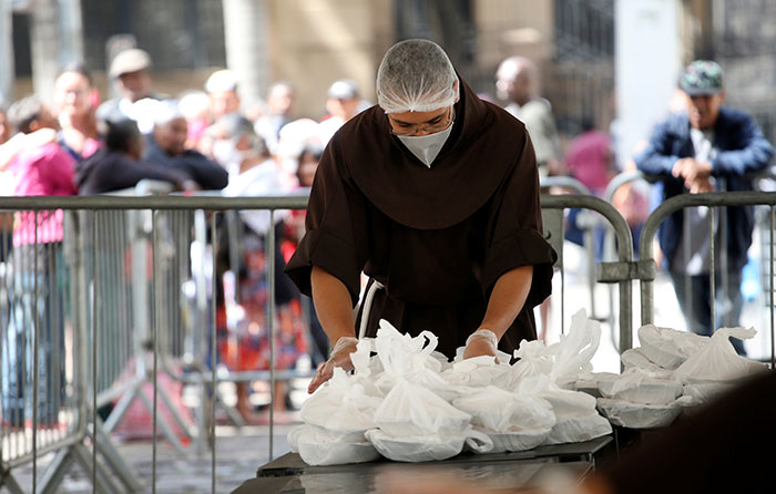 After World Mission Sunday Mass at St. Ferdinand Church, pastor Father Jason Torba and Cardinal Blase Cupich greet the congregation, including all those who do mission in Chicago. (Julie Jaidinger, Chicago Catholic/U.S.)