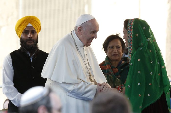 Pope Francis greets Sabera Ahmadi, a recent refugee from Afghanistan, during a meeting with other religious and political leaders meet in front of the Colosseum in Rome Oct. 7, 2021. The meeting was held to plead and pray for peace. Also pictured is Jaswant Singh, left, member of the presiding committee of a Sikh council in Italy, and Lakshmi Vyas, president of the Hindu Forum of Europe. (CNS photo/Paul Haring)