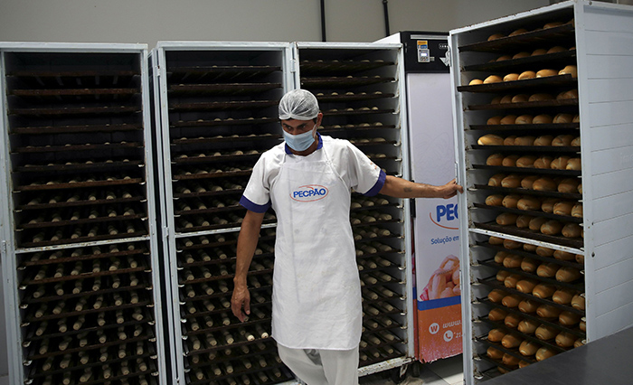 A baker works at a bakery at the Sanctuary of Our Lady of Fatima, where bread is produced to be distributed to vulnerable people due to food insecurity, during the COVID-19 outbreak, in Rio de Janeiro June 2, 2021. A report released in late November by several United Nations’ agencies warned that the number of those suffering from hunger in Latin America and the Caribbean is at its highest point in 15 years. (CNS photo/Ricardo Moraes, Reuters)