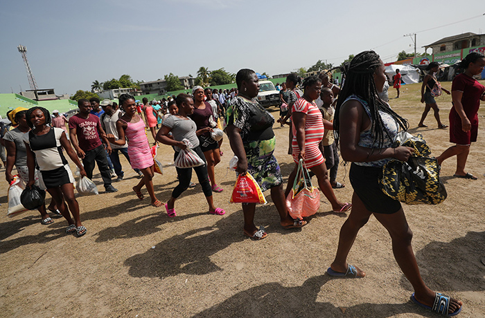 Residents who were evacuated from their homes after an earthquake walk after receiving food at a stadium in Les Cayes, Haiti, in this Aug. 23, 2021, file photo. A report released in late November by several United Nations’ agencies warned that the number of those suffering from hunger in Latin America and the Caribbean is at its highest point in 15 years. (CNS photo/Henry Romero, Reuters)