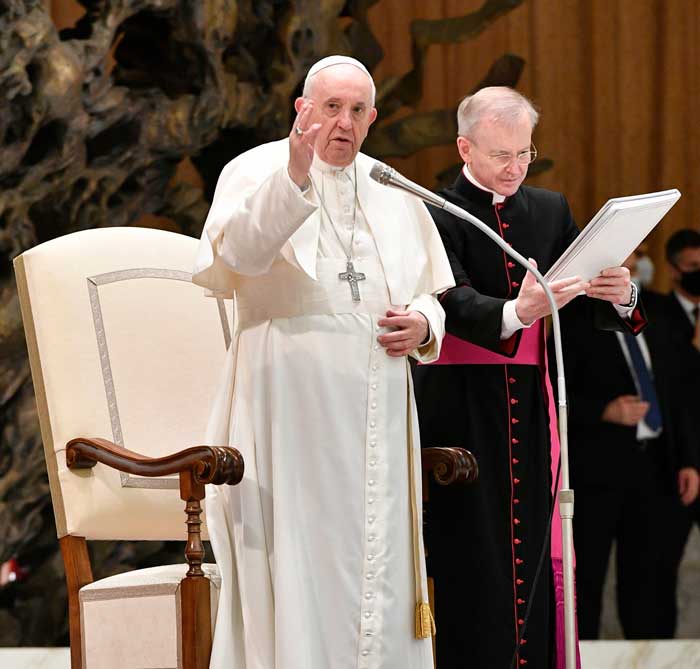 Holy family fled Herod pope recalls: Pope Francis gives his blessing at the end of his weekly general audience Dec. 29, 2021, in the Vatican's Paul VI hall. (CNS photo/Vatican Media)