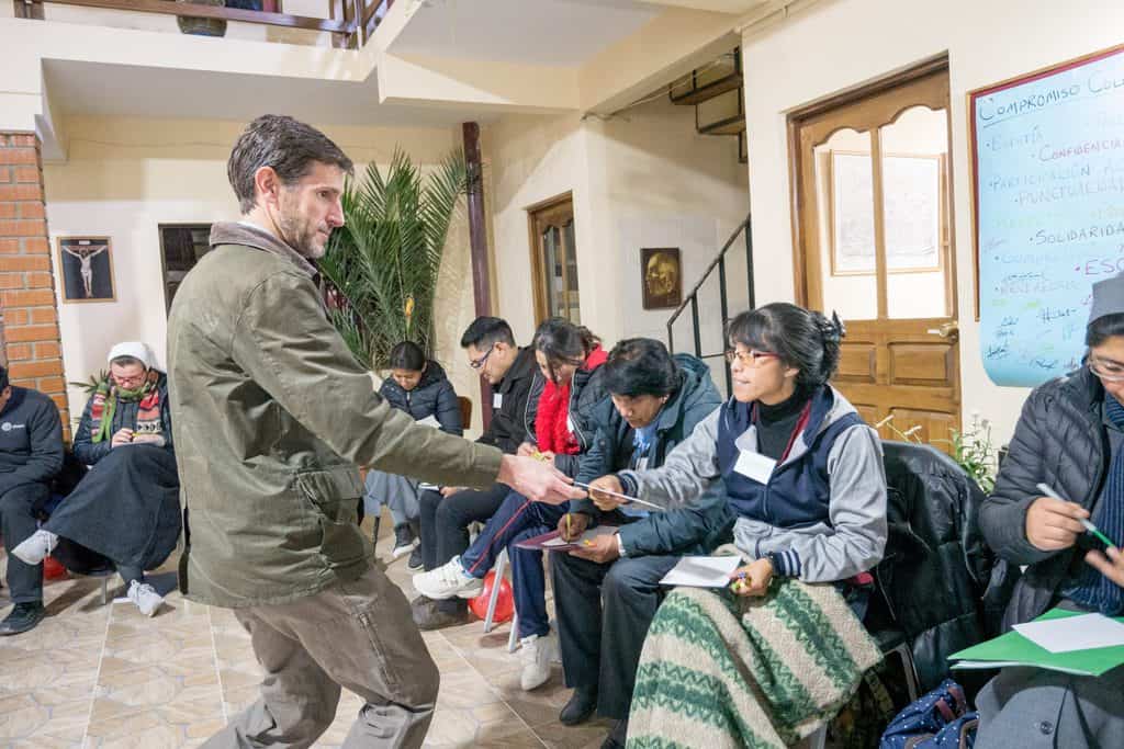 Maryknoll Affiliate Jason Obergfell, a facilitator, hands out material to be used in an ESPERE workshop at a Jesuit parish in Oruru, Bolivia. (Nile Sprague/Bolivia)