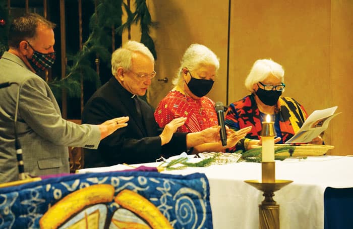 Maryknoll leaders (l. to r.) Ted Miles, Father Lance Nadeau, Sister Teruko Ito and Lay Missioner Marj Humphrey bless crosses for the new missioners. (Patrick Norberto/U.S.)