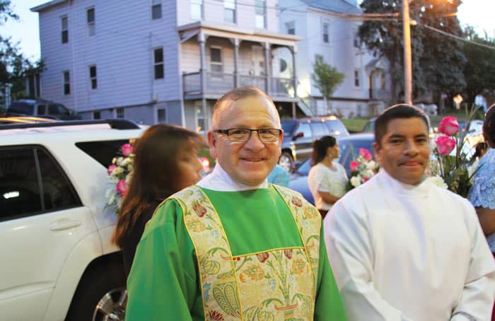 After World Mission Sunday Mass at St. Ferdinand Church, pastor Father Jason Torba and Cardinal Blase Cupich greet the congregation, including all those who do mission in Chicago. (Julie Jaidinger, Chicago Catholic/U.S.)